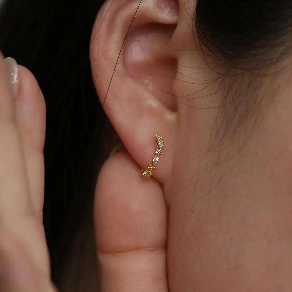 Flower cubic semi-hoop earrings by Nabi London