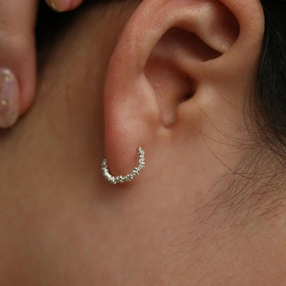 Flower cubic semi-hoop earrings by Nabi London