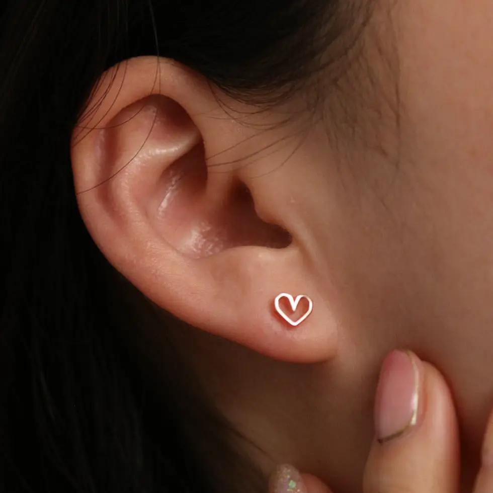 Angled heart stud earrings by Nabi London