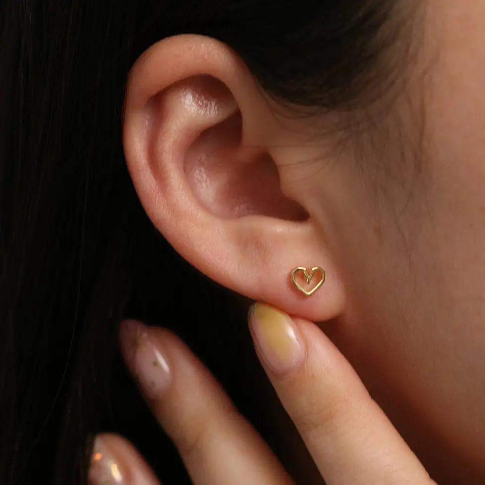 Angled heart stud earrings by Nabi London