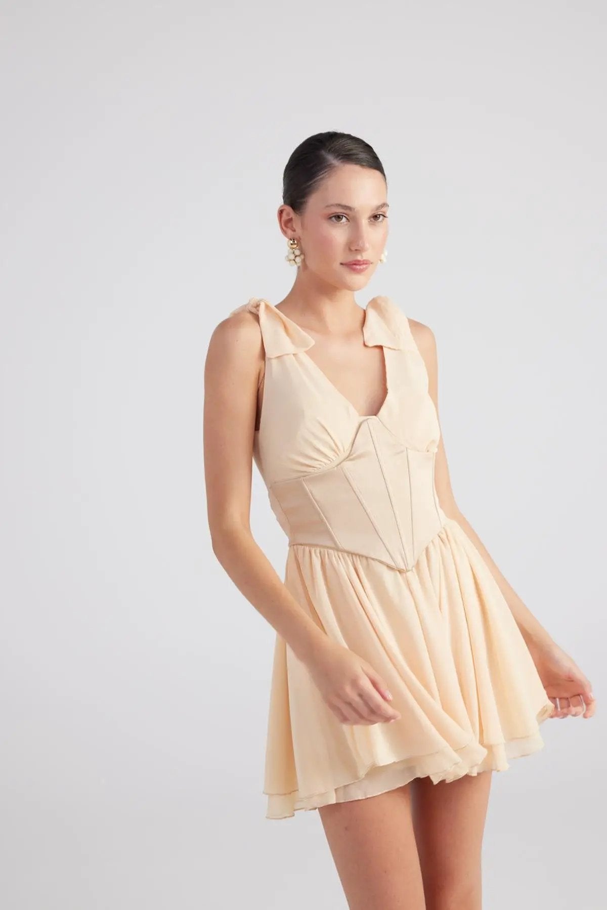 Fiona Beige Ruched Mini Dress with Pleated Skirt by Holly Lolly
