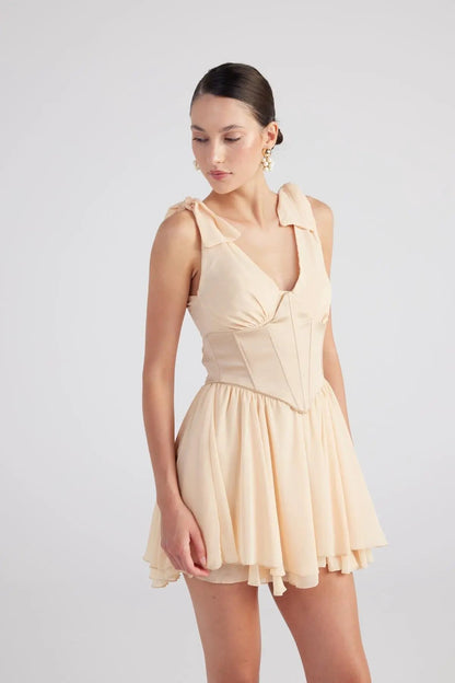 Fiona Beige Ruched Mini Dress with Pleated Skirt by Holly Lolly